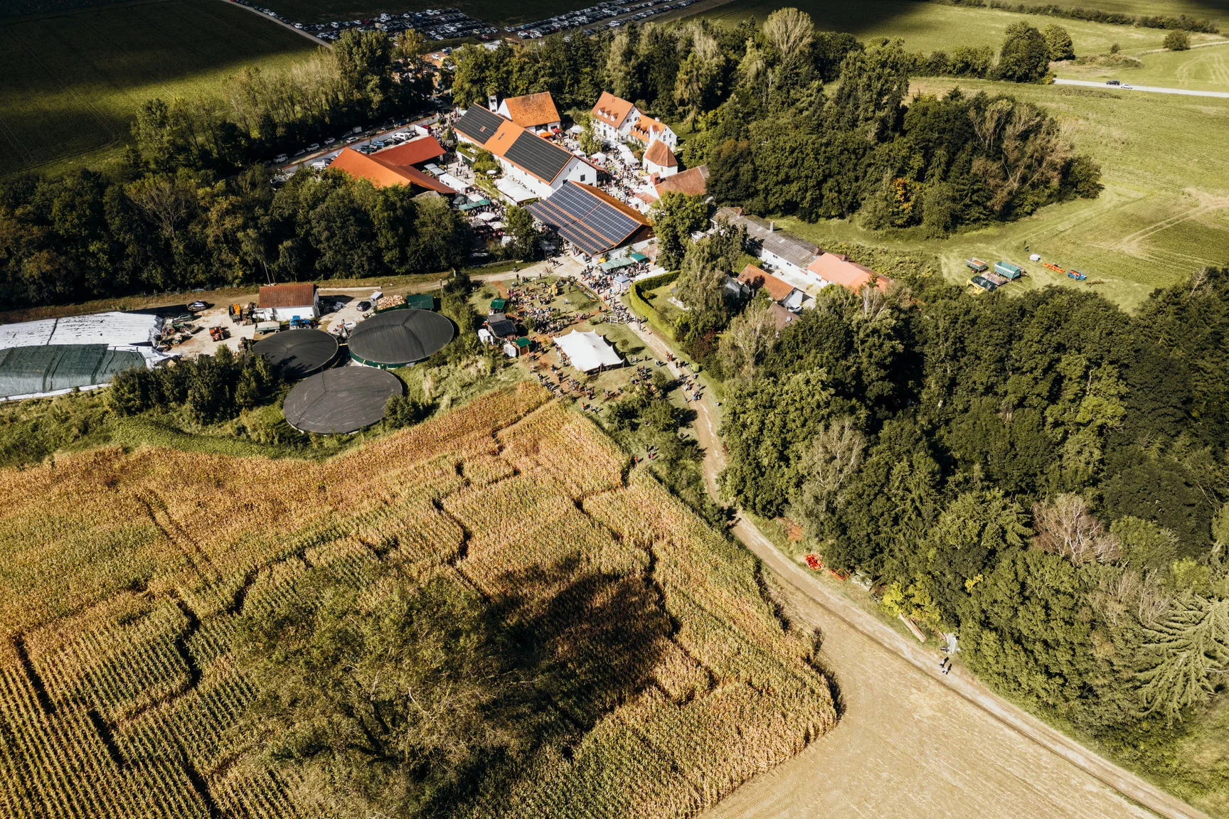 Aerial view of Hofgut Sickertshofen with biogas plant solar panels and fields for sustainable corporate events